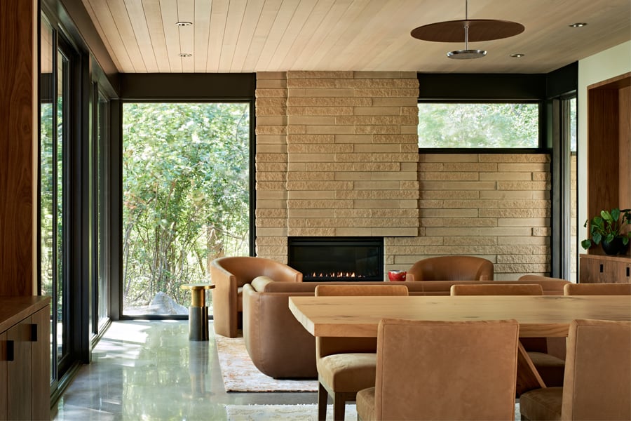 Mid-Century Modern home with floor to ceiling windows alongside a cozy fireplace