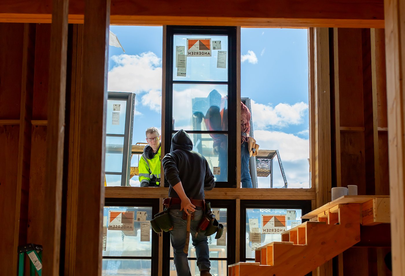 A crew installs windows in a new construction home.