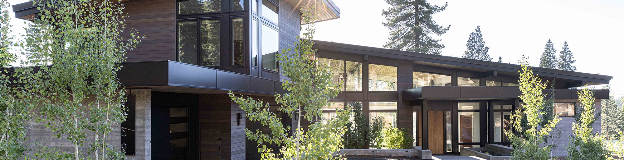 Modern style home with low pitch roof and an abundance of windows