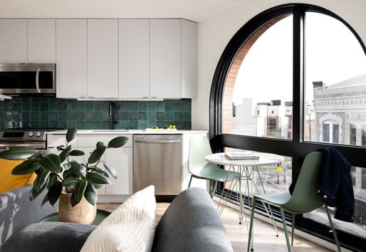 An apartment with a large arched window combination unit made of Andersen® E-Series Specialty Windows.
